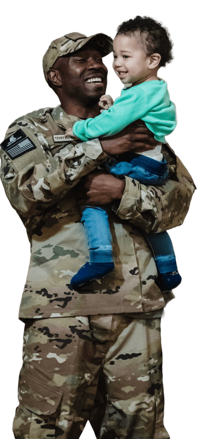 Picture of a smiling veteran picking up a small, smiling child.